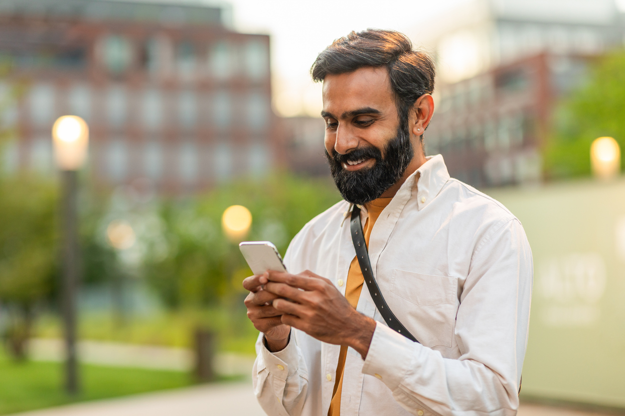 A man uses his phone to text a homebuilder’s digital assistant that uses multilingual AI.